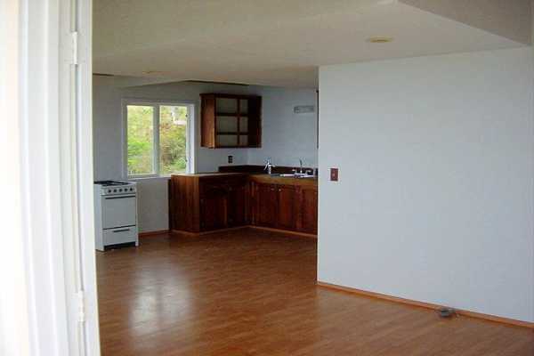 88-2256 Milolii Road Captain Cook, HI 96704 - Photo 9 of 15 a kitchen with granite countertop a stove and a wooden floor