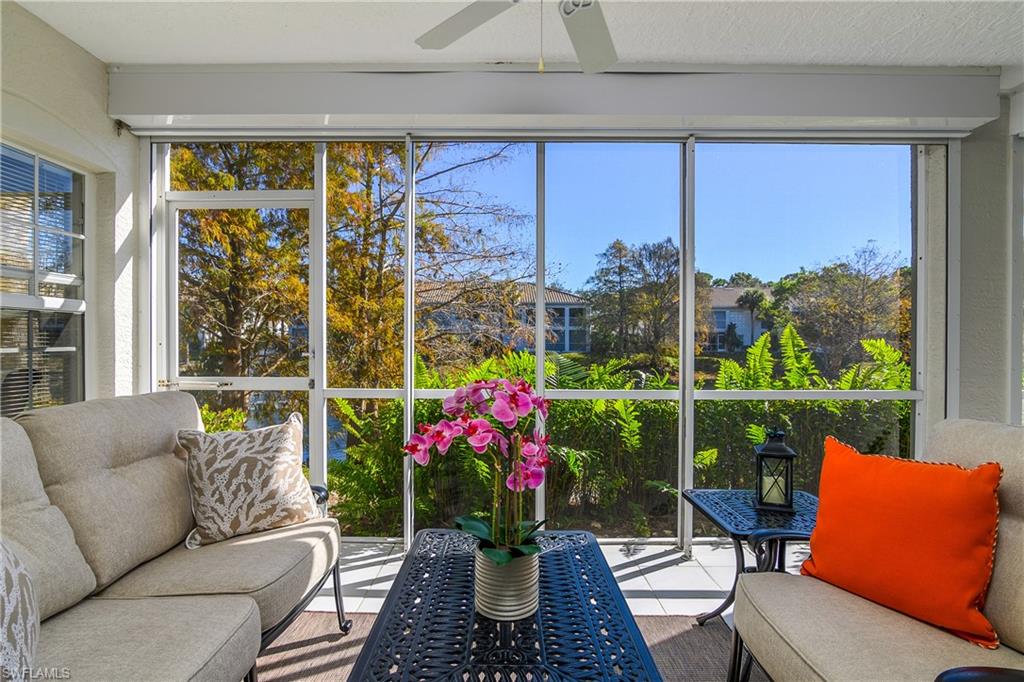 6838 Lantana Bridge Road, Unit 103 Naples, FL 34109 - Photo 27 of 41 a living room with patio furniture and a potted plant
