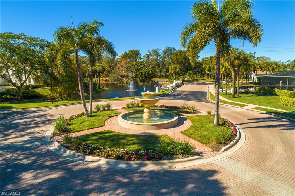 6838 Lantana Bridge Road, Unit 103 Naples, FL 34109 - Photo 32 of 41 a view of a swimming pool with a garden