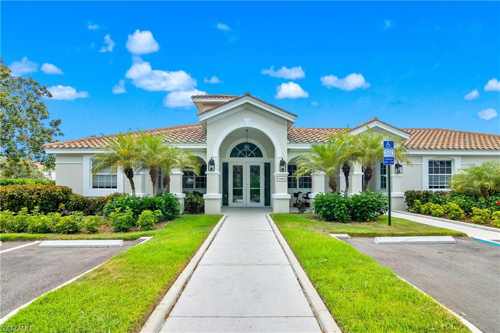 6838 Lantana Bridge Road, Unit 103 Naples, FL 34109 - Photo 40 of 41 a view of a house with a yard and potted plants