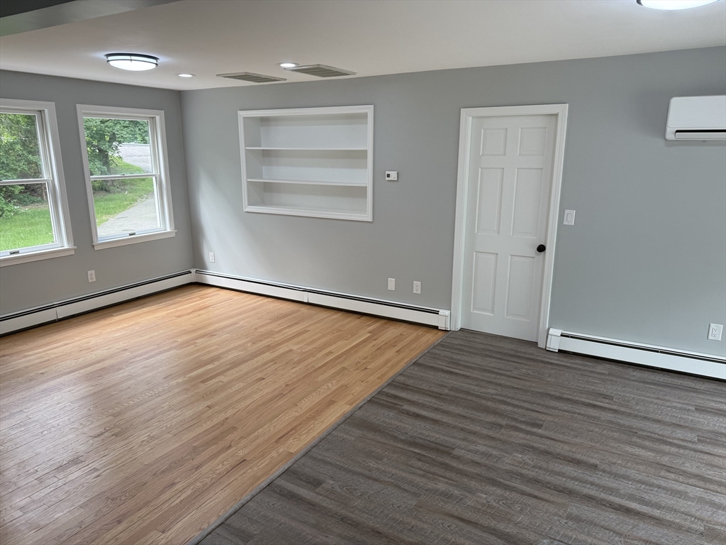 295 Frenchtown Road East Greenwich, RI 02818 - Photo 4 of 26 an empty room with wooden floor and windows