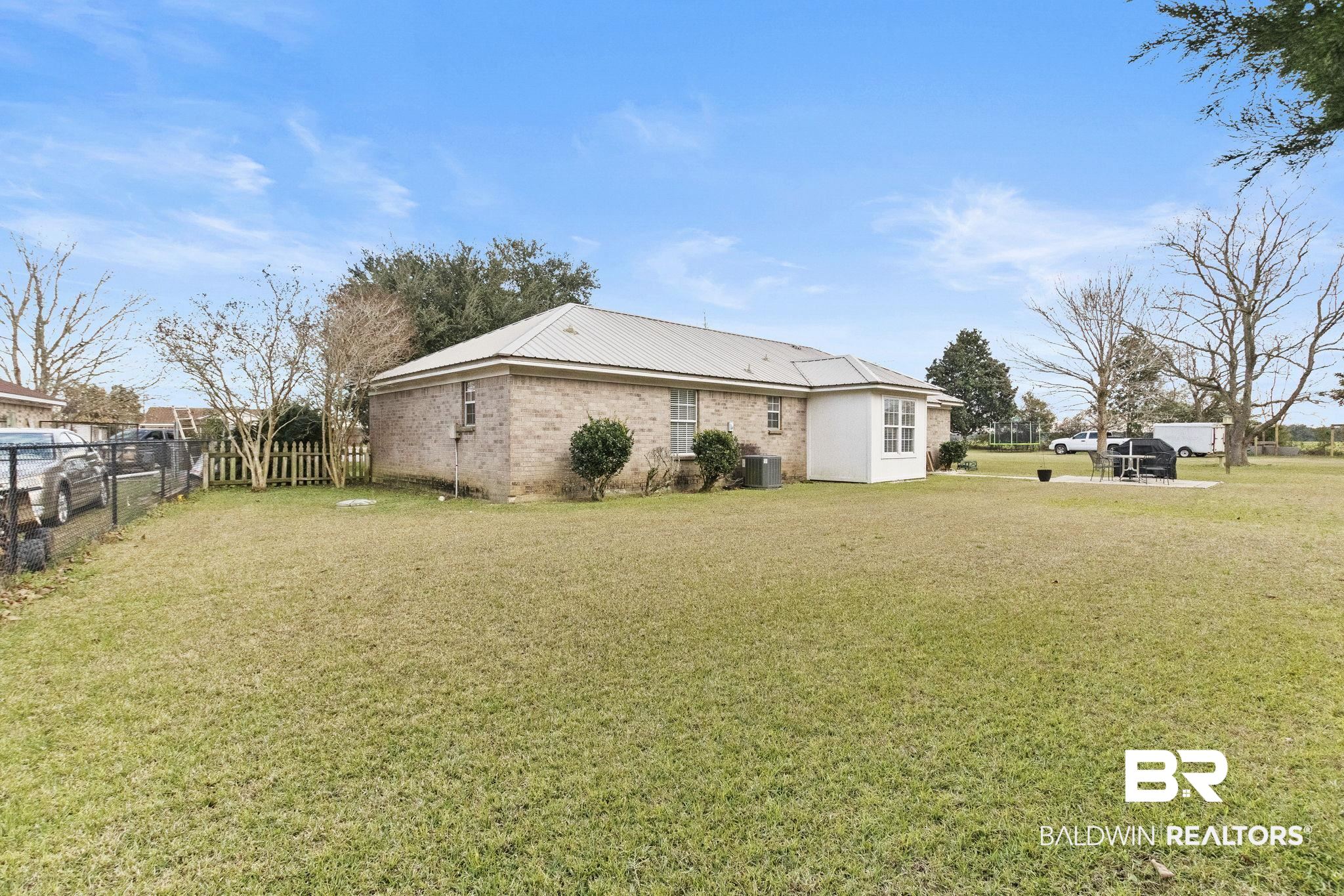 14031 Brook Hollow Road Summerdale, AL 36580 - Photo 48 of 56 View of home's exterior with a yard and cooling unit