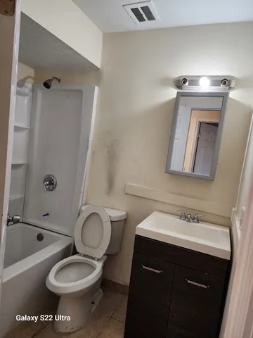 a bathroom with a sink toilet a mirror and shower