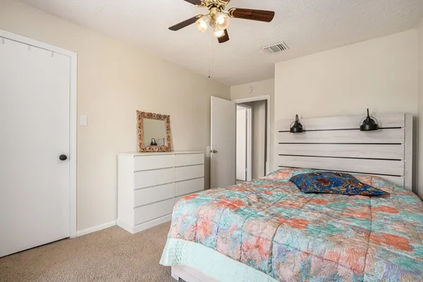 a bedroom with a bed and window