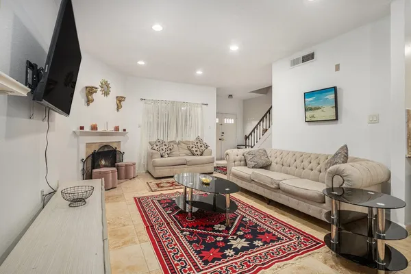 a living room with furniture fireplace and flat screen tv