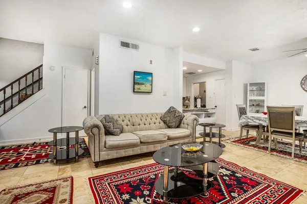 a living room with furniture or couch and a piano
