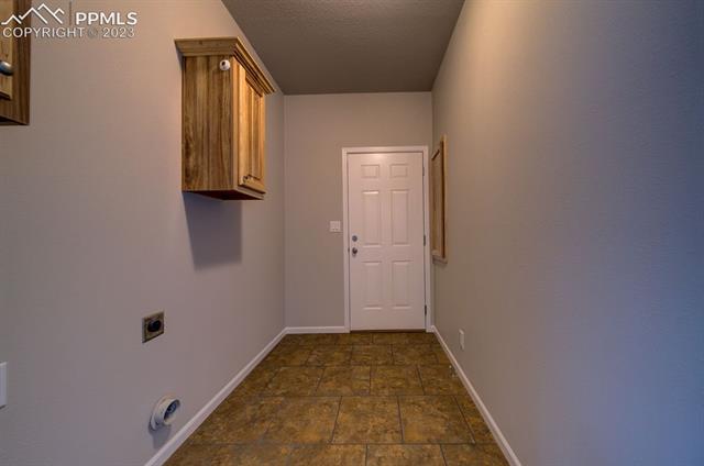 13615 Mc Cune Road Elbert, CO 80106 - Photo 28 of 31 Laundry Room w/Laminate flooring and 2 hickory cabinets w/hanger section
