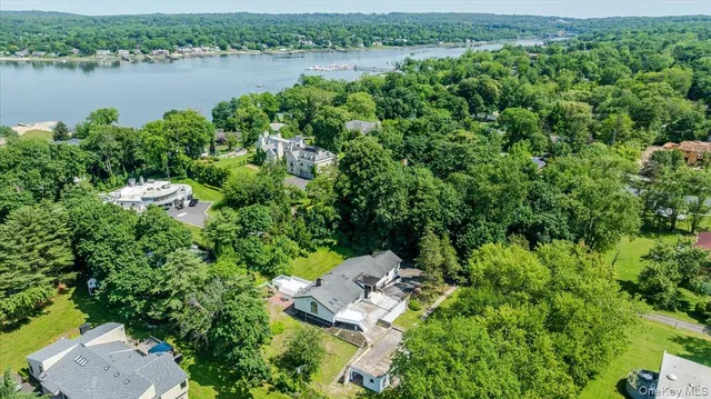 an aerial view of a house with a yard and lake view
