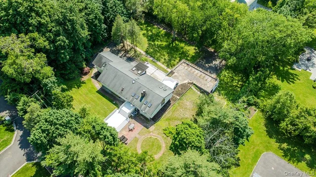 an aerial view of a house with a yard