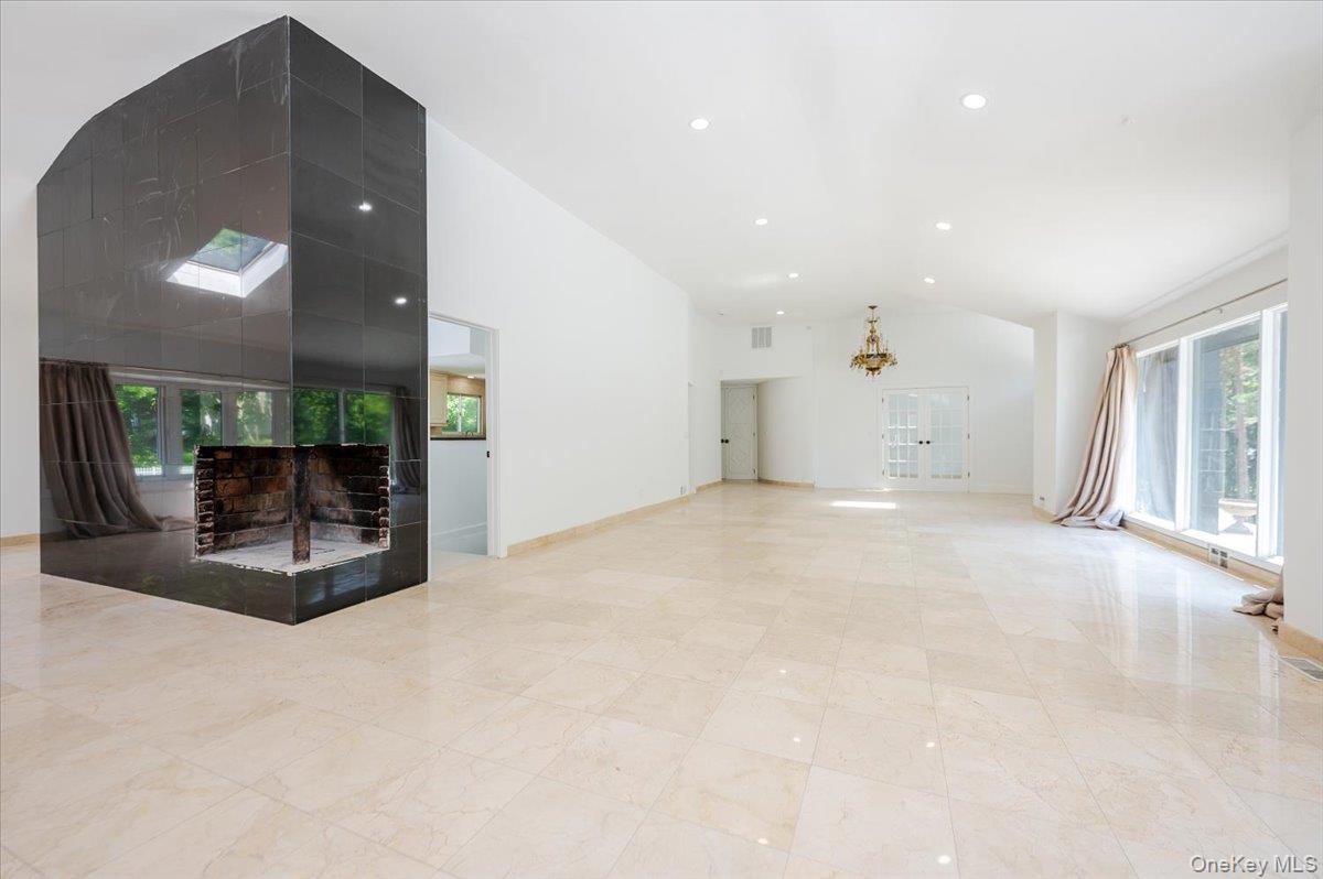 452 East Shore Road Great Neck, NY 11024 - Photo 6 of 35 a view of a livingroom with furniture and a fireplace