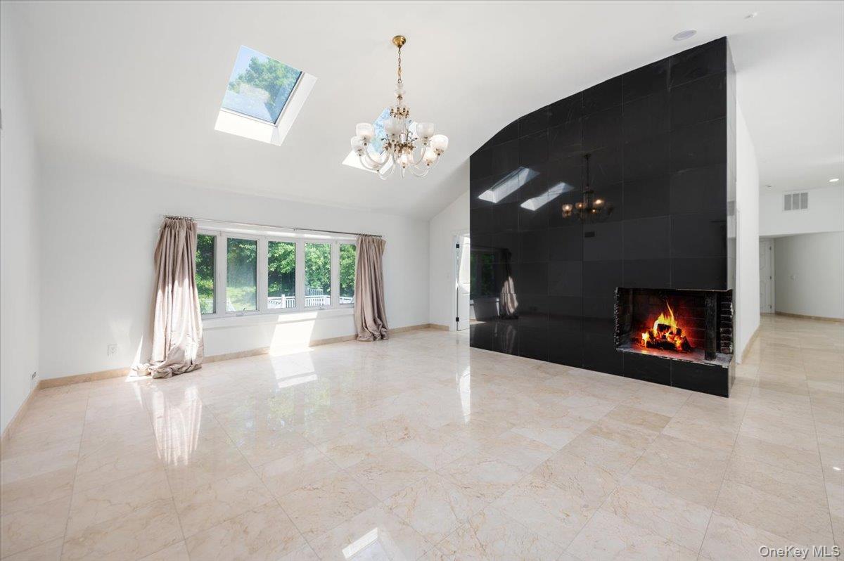 452 East Shore Road Great Neck, NY 11024 - Photo 7 of 35 a view of an empty room with a fireplace