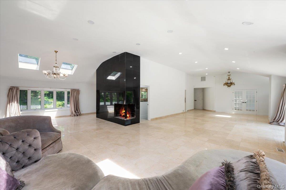 452 East Shore Road Great Neck, NY 11024 - Photo 8 of 35 a living room with furniture and a fireplace