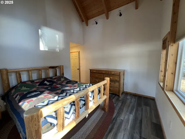 a bedroom with furniture and a wooden floor