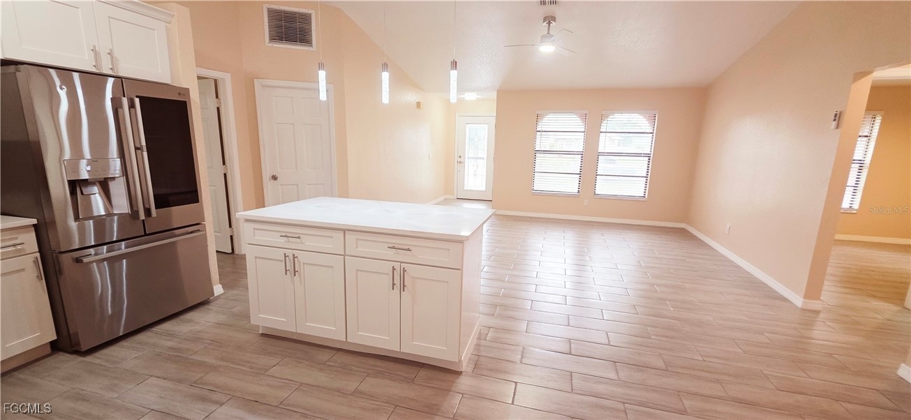 930 Southwest 34th Street Cape Coral, FL 33914 - Photo 11 of 31 a kitchen with stainless steel appliances a refrigerator sink and cabinets