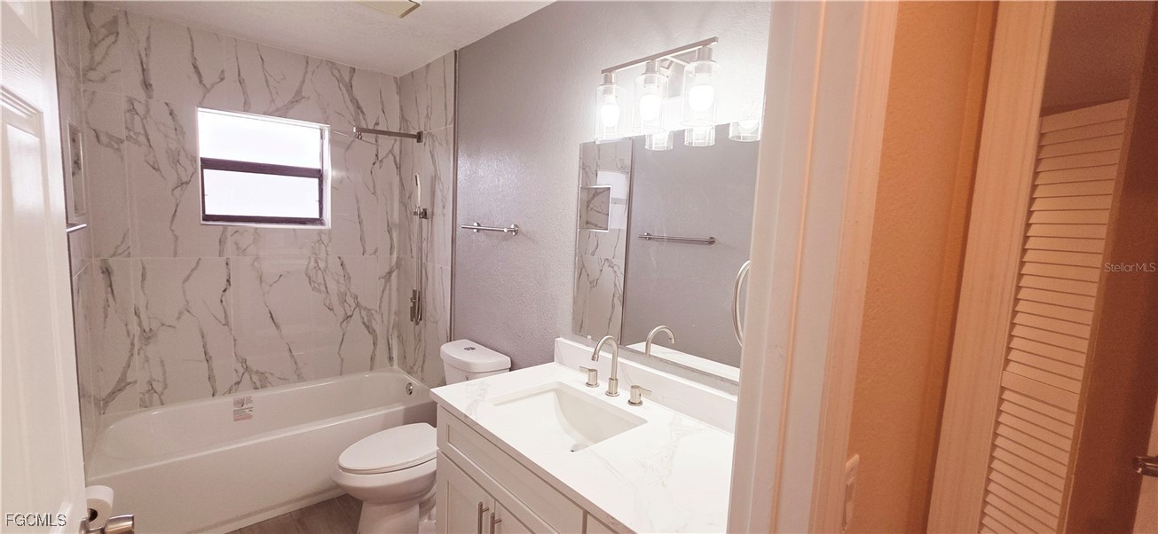 930 Southwest 34th Street Cape Coral, FL 33914 - Photo 13 of 31 a bathroom with a bathtub shower sink vanity mirror and toilet