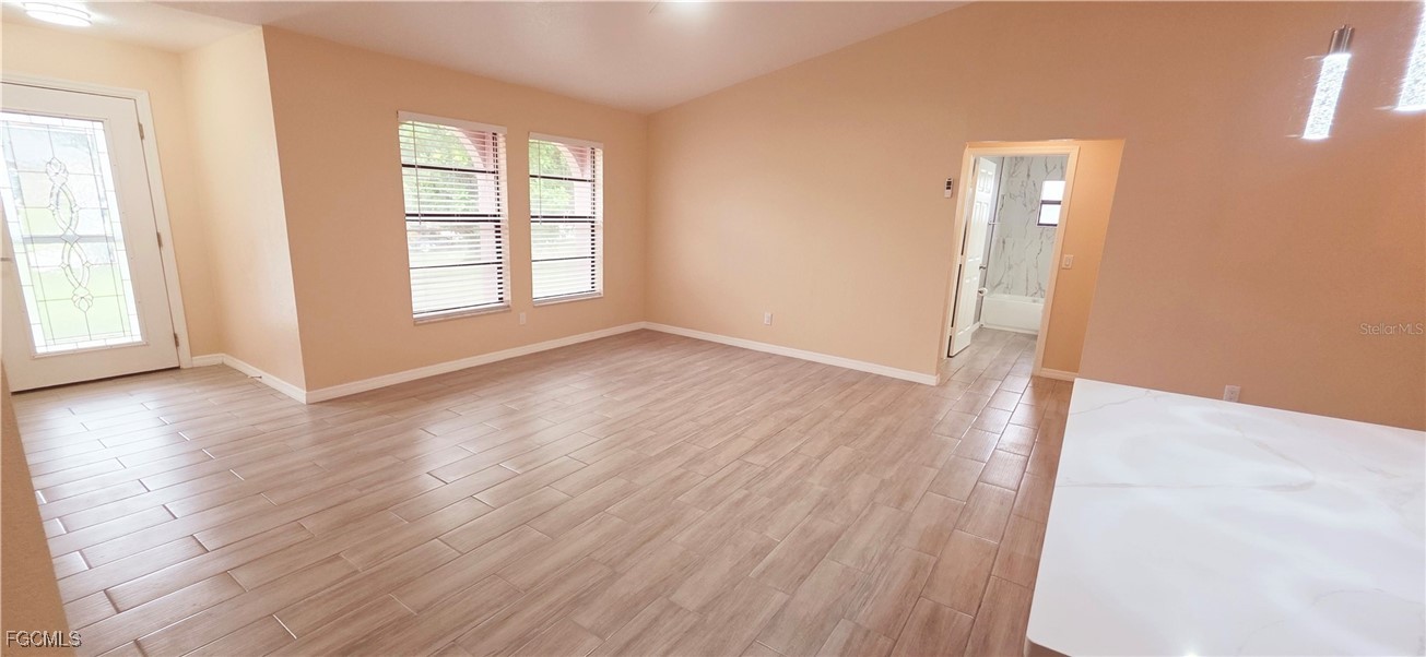 930 Southwest 34th Street Cape Coral, FL 33914 - Photo 17 of 31 an empty room with wooden floor and windows