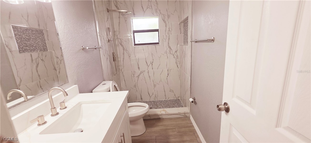 930 Southwest 34th Street Cape Coral, FL 33914 - Photo 18 of 31 a bathroom with a sink a toilet and shower curtain