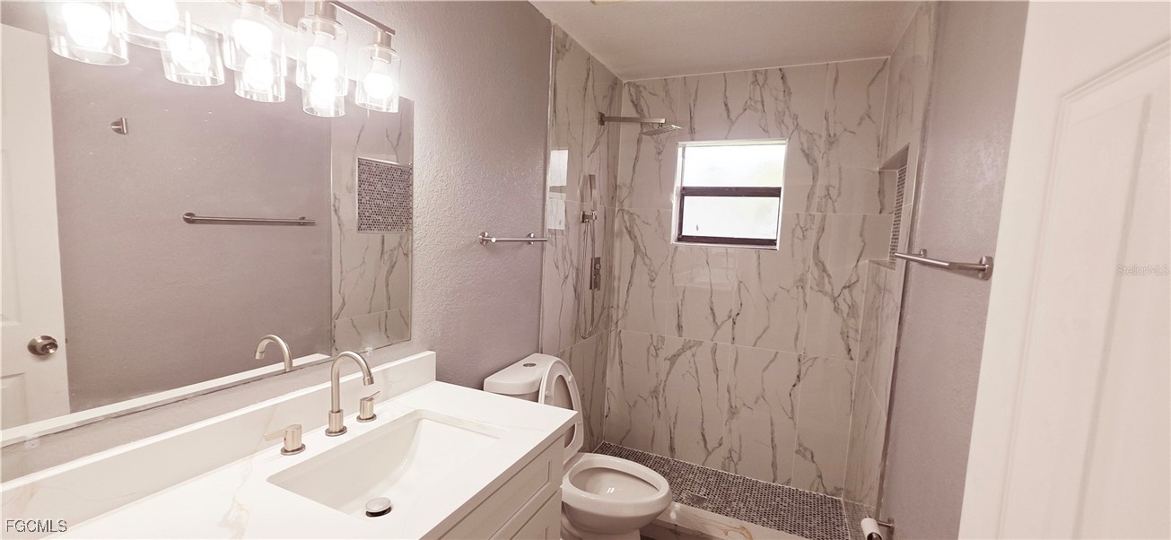 930 Southwest 34th Street Cape Coral, FL 33914 - Photo 20 of 31 a bathroom with a sink a toilet and shower