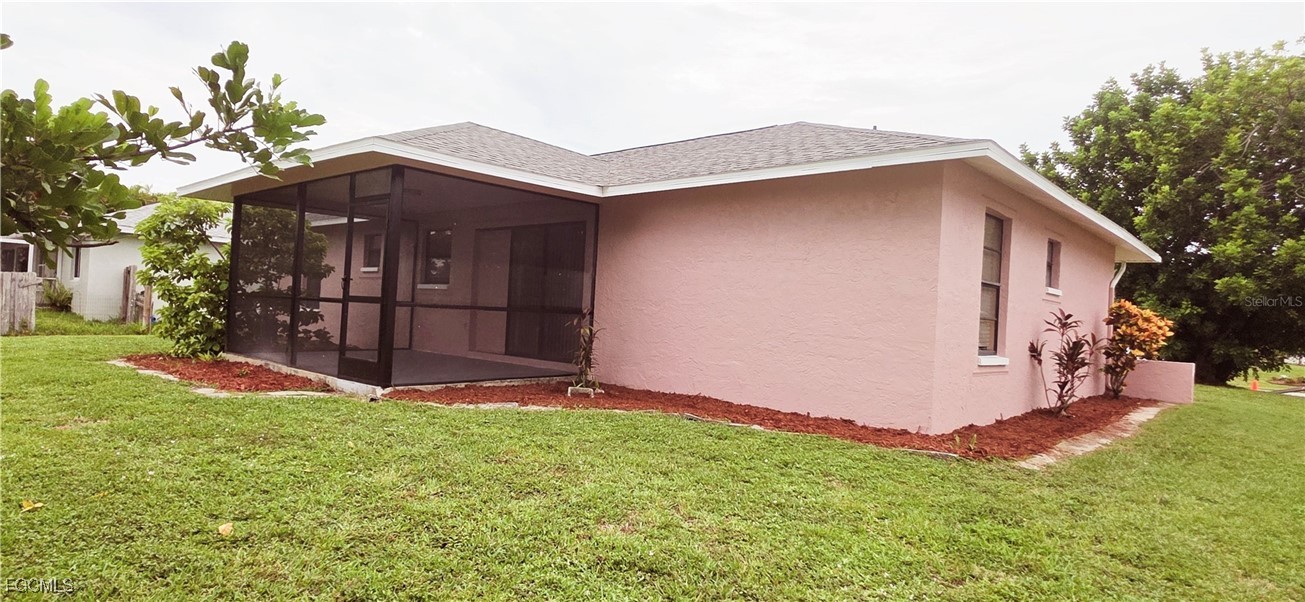 930 Southwest 34th Street Cape Coral, FL 33914 - Photo 25 of 31 a backyard of a house with lots of green space