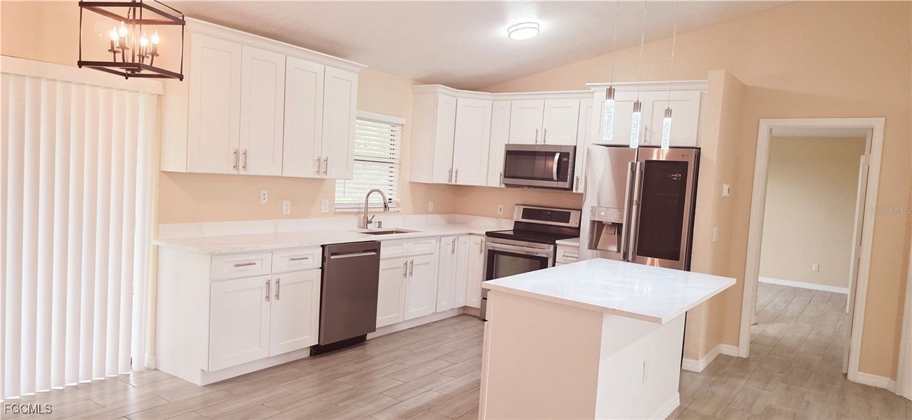930 Southwest 34th Street Cape Coral, FL 33914 - Photo 26 of 31 a kitchen with white cabinets and stainless steel appliances