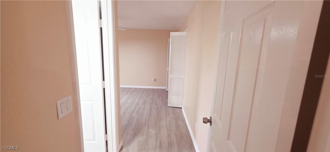 930 Southwest 34th Street Cape Coral, FL 33914 - Photo 30 of 31 a view of a hallway with wooden floor