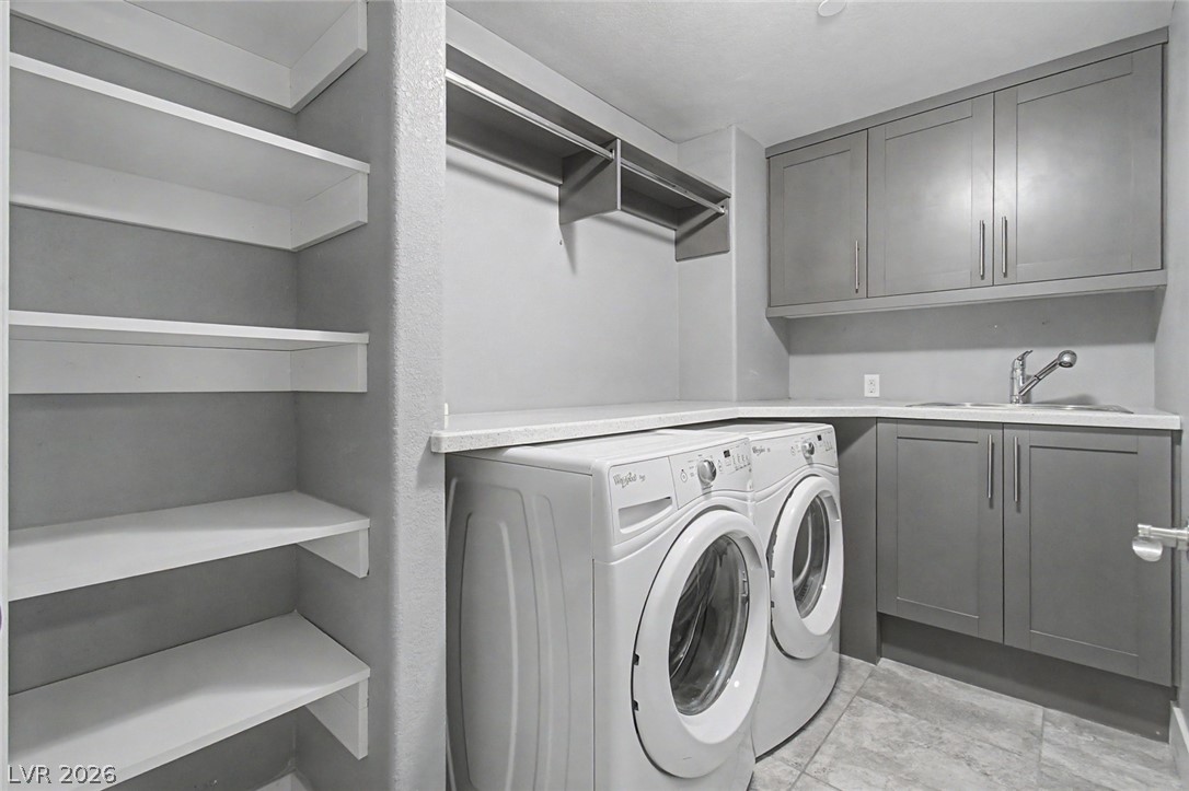 2555 Hampton Road, Unit 6308 Henderson, NV 89052 - Photo 13 of 30 Laundry room featuring a utility sink, counters plus plentiful storage cabinets & built-in shelving.