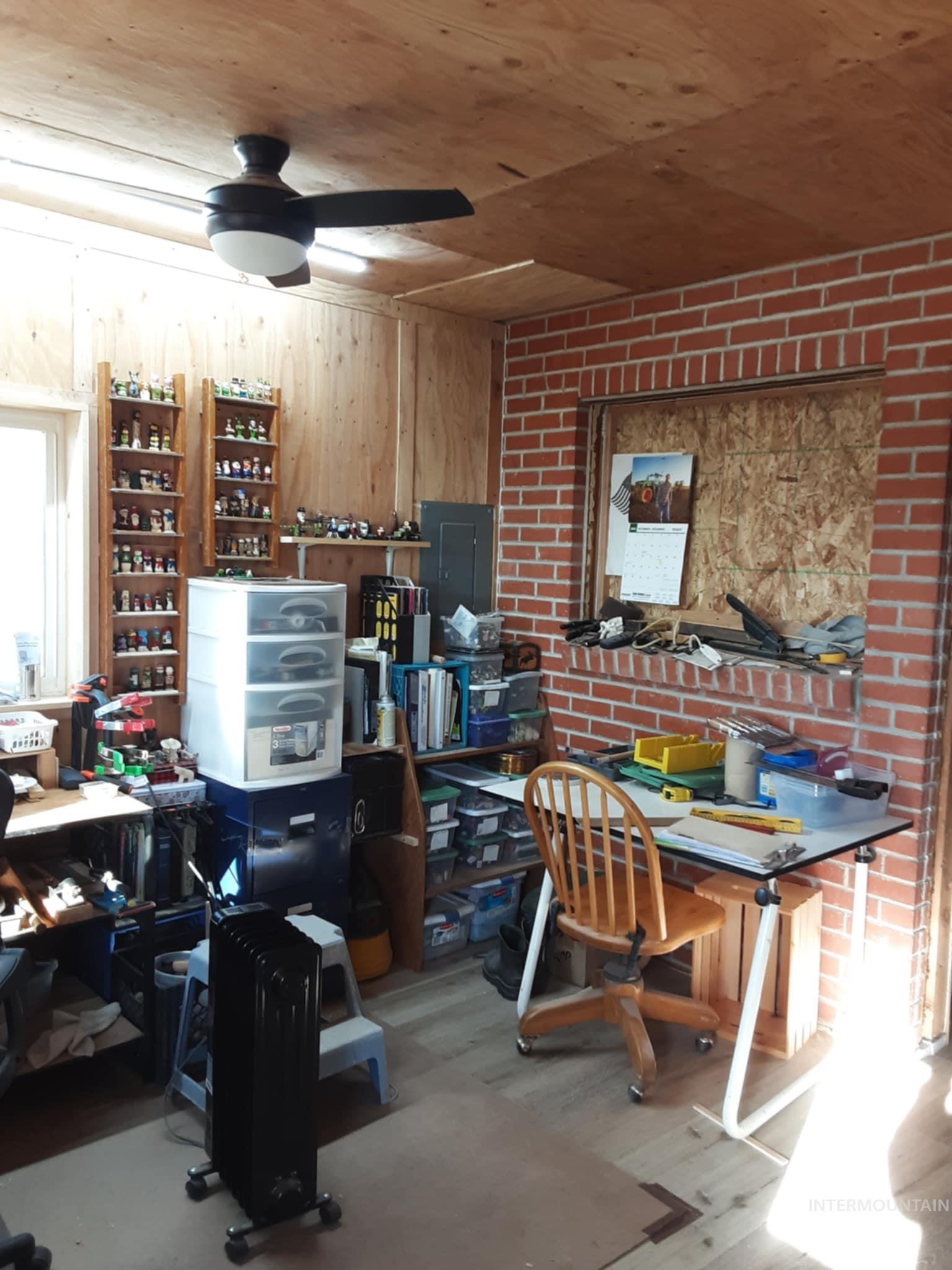 145 North Lincoln Avenue Oakley, ID 83346 - Photo 17 of 48 Office with light wood-type flooring, wooden walls, electric panel, ceiling fan, and wood ceiling