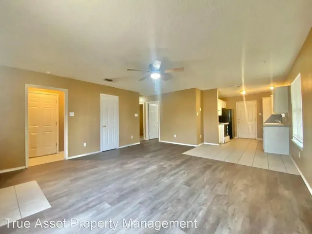 a large bathroom with a large mirror vanity and shower