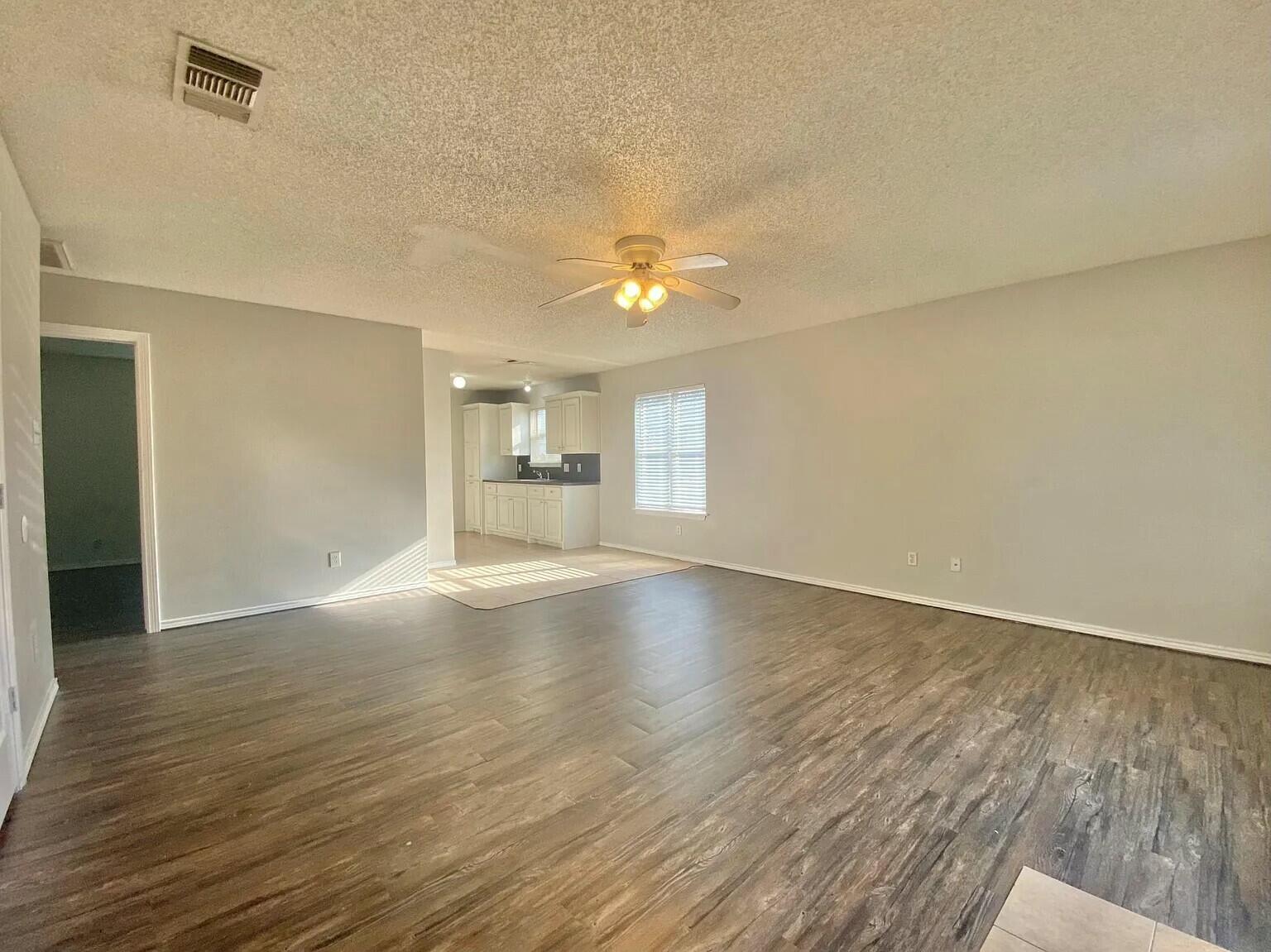Package Package Property Lubbock, TX 79415 - Photo 2 of 45 wooden floor in an empty room with a window