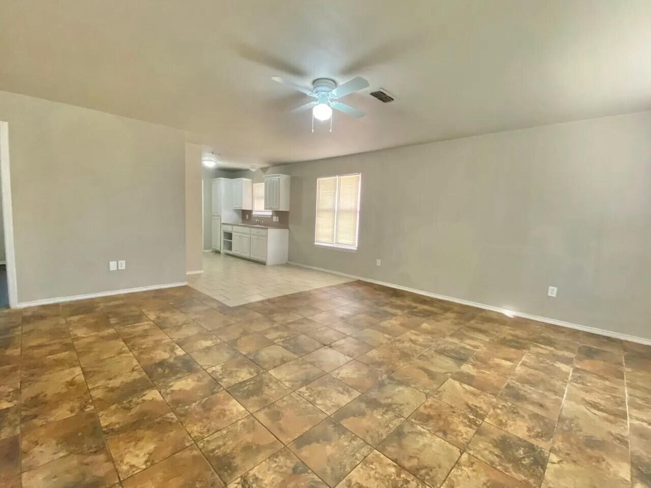 Package Package Property Lubbock, TX 79415 - Photo 23 of 33 a view of a livingroom with a chandelier fan and kitchen view