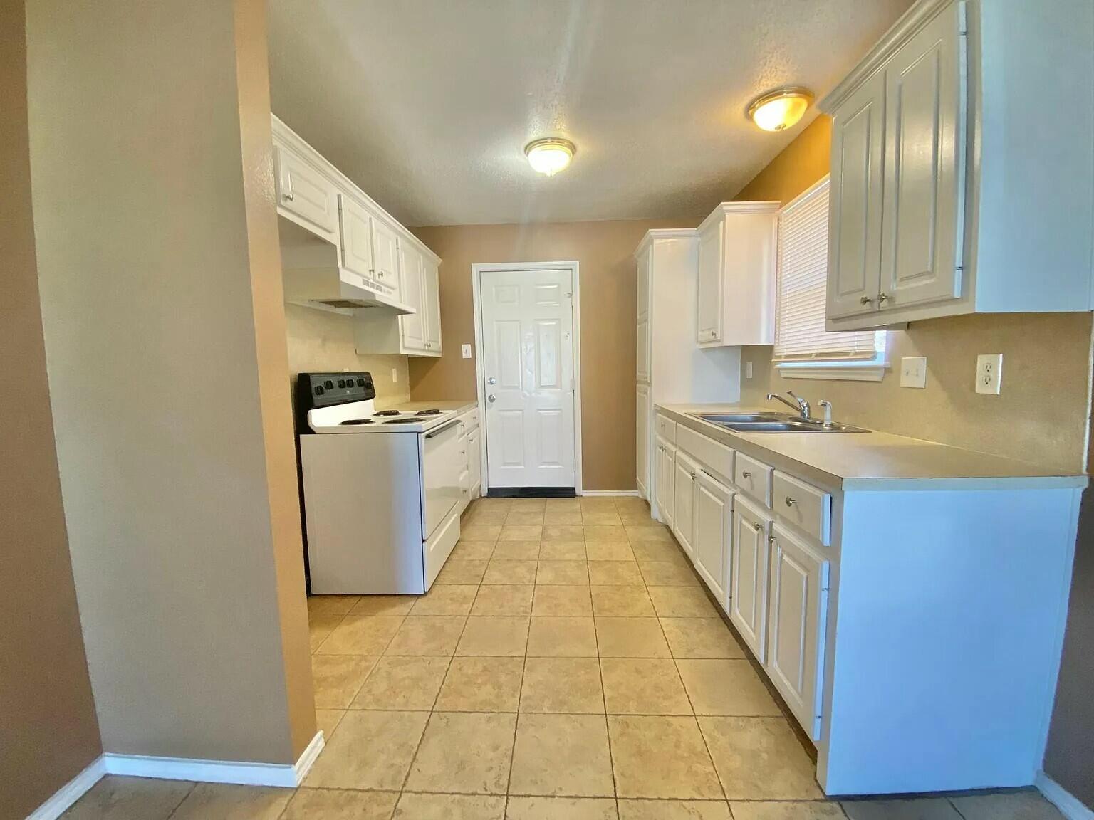 Package Package Property Lubbock, TX 79415 - Photo 23 of 45 a kitchen with stainless steel appliances granite countertop a stove a sink a refrigerator white cabinets and wooden floor