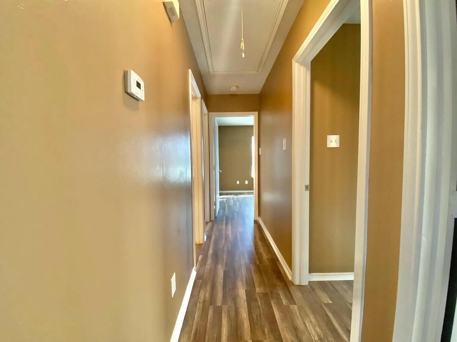 Package Package Property Lubbock, TX 79415 - Photo 24 of 45 a view of a hallway with wooden floor
