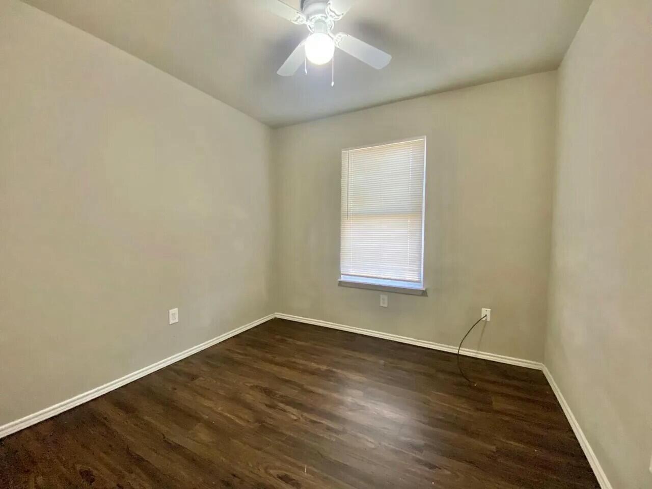 Package Package Property Lubbock, TX 79415 - Photo 26 of 33 an empty room with wooden floor and windows