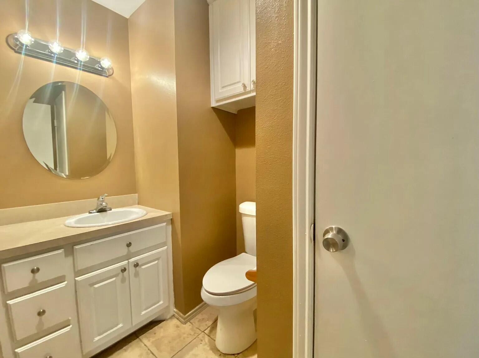 Package Package Property Lubbock, TX 79415 - Photo 29 of 45 a bathroom with a toilet a sink a mirror and vanity