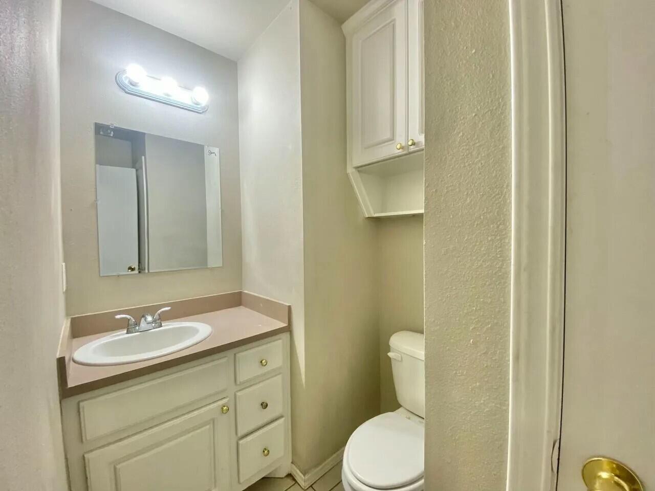 Package Package Property Lubbock, TX 79415 - Photo 30 of 33 a bathroom with a granite countertop sink toilet and mirror
