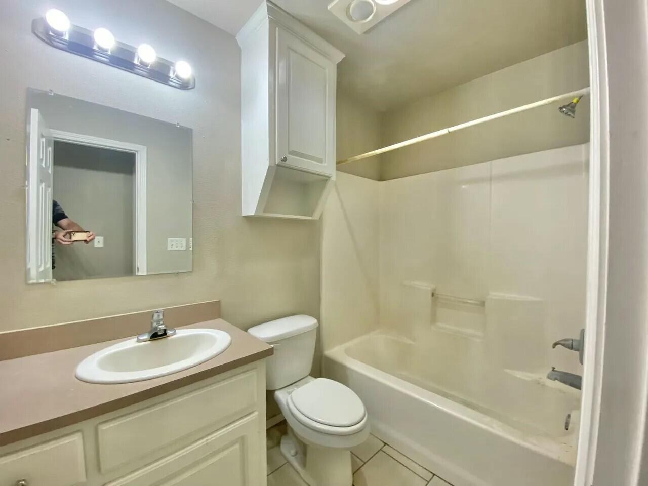 Package Package Property Lubbock, TX 79415 - Photo 39 of 45 a bathroom with a sink toilet a mirror and shower