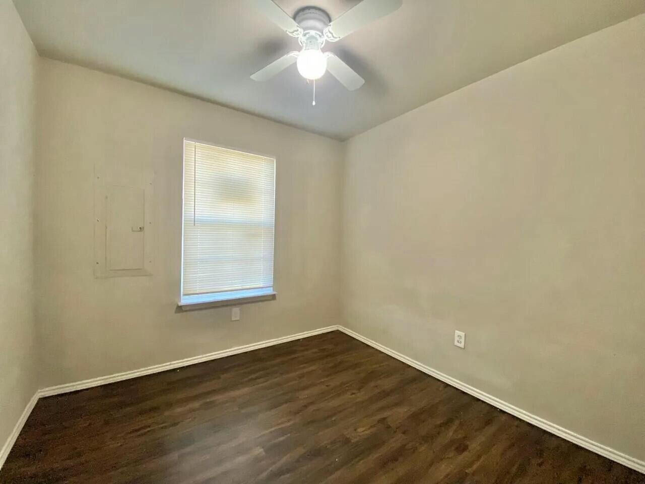 Package Package Property Lubbock, TX 79415 - Photo 40 of 45 an empty room with wooden floor and windows