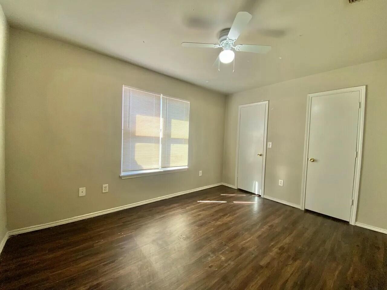 Package Package Property Lubbock, TX 79415 - Photo 41 of 45 an empty room with wooden floor and windows