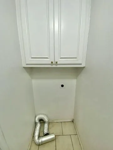 a view of a yard with wooden fence