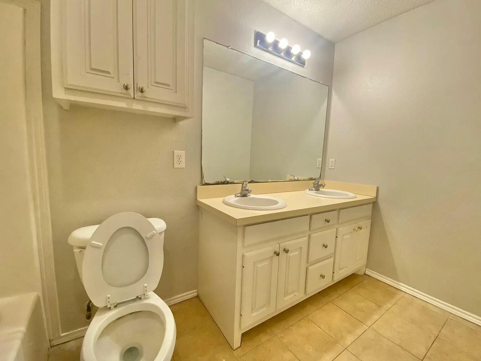 Package Package Property Lubbock, TX 79415 - Photo 9 of 45 a bathroom with a toilet sink and mirror