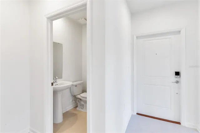 a bathroom with a sink a toilet and a window