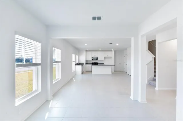 a view of a living room a window and kitchen view