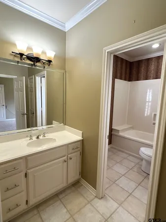 a spacious bathroom with a double vanity sink a mirror and a shower