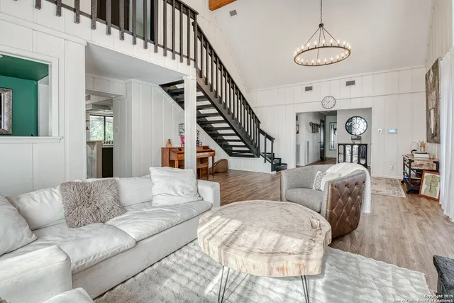 a living room with furniture or stairs and a wooden floor