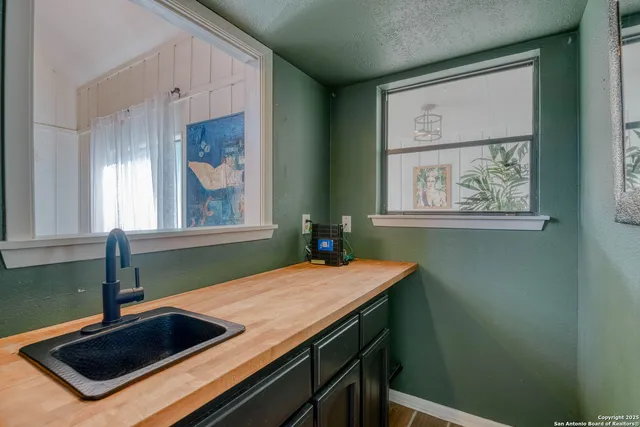a kitchen with a sink cabinets and a window