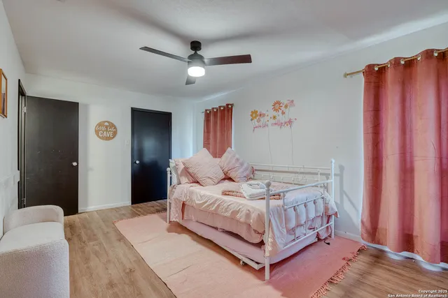 a bedroom with a large bed and a chandelier