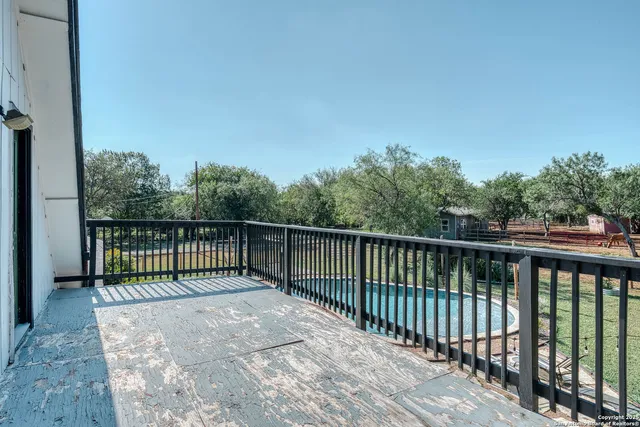 a balcony with trees in front of it