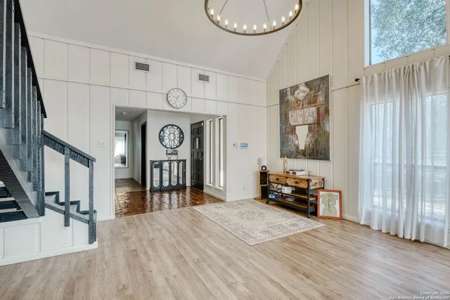 a bedroom with a bed and a large mirror on the dresser
