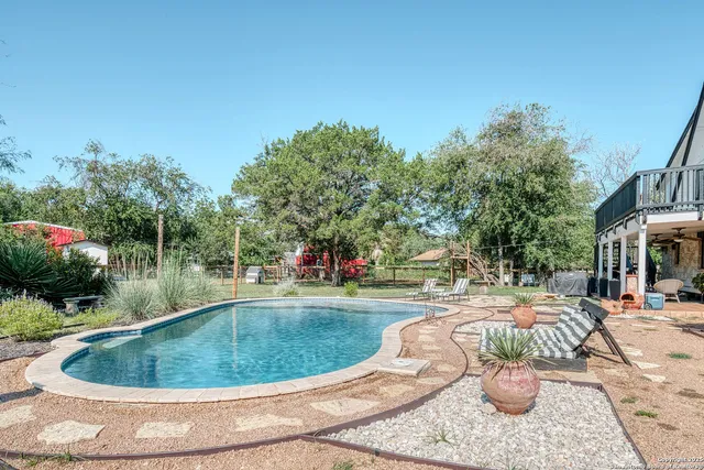 a view of a swimming pool with a patio