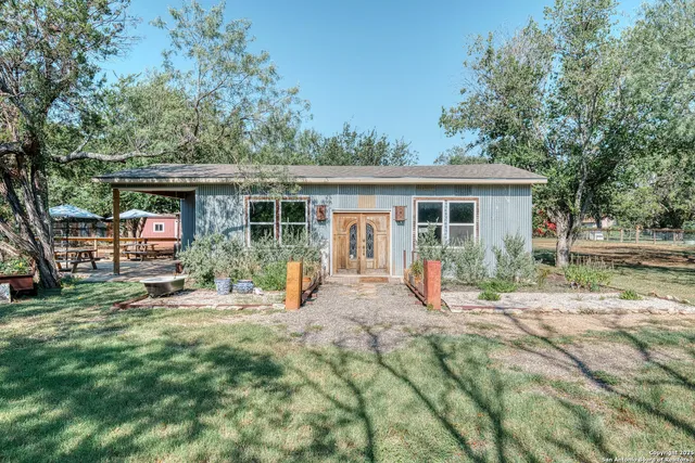 a view of a house with backyard porch and sitting area